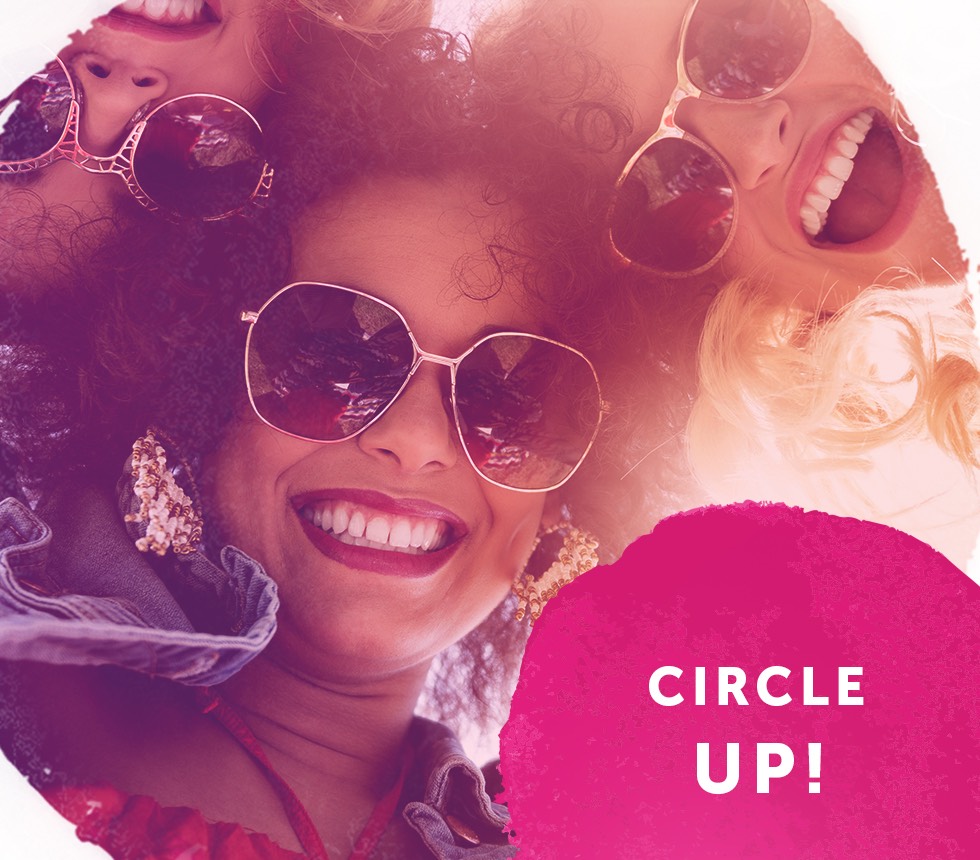 Three women with sunglasses smiling looking down at the camera with a pink ink stain overlaid with the text Circle Up!